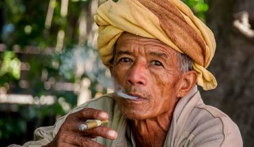 Burmese man smoking traditional handmade cigar