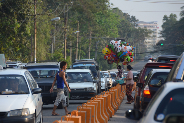 Traffic Jam in Yangon and the locals crossing the road by over the fence