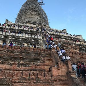 people climb to the top of shwenandaw pagoda to capture the sunset view in Bagan