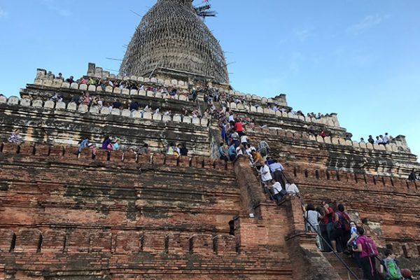 people climb to the top of shwenandaw pagoda to capture the sunset view in Bagan