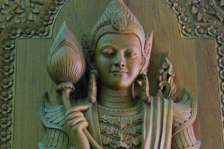 This exquisite carving of a nat spirit adorns one of the main doors to the Mahapasana Cave in Yangon