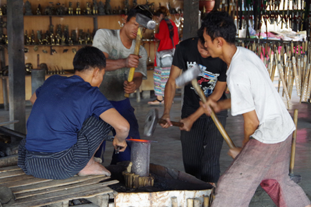 Burmese men in a blacksmith workshop