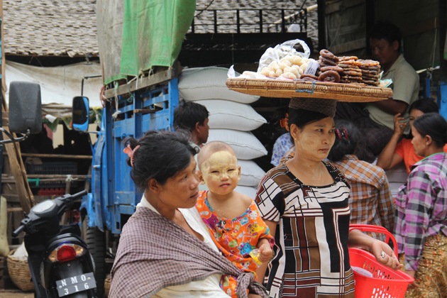 A baby with thanaka on face, Nyaung U Market
