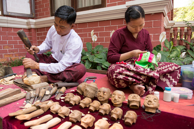 Burmese couple carving puppets