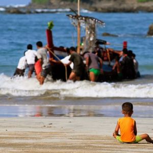 Local child playing and waiting his father come back from the sea trip in Maung Shwe Lay fishing village