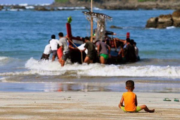 Local child playing and waiting his father come back from the sea trip in Maung Shwe Lay fishing village