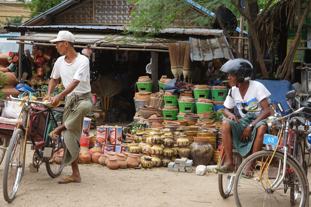 Two men with their bike in a short break before loading goods in Nyaung Market