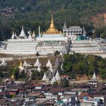 behold a gilded temple in Mogok at a far distance