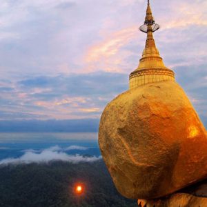 the massive golden rock is where people gather to pay homage