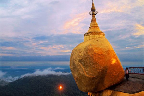 the massive golden rock is where people gather to pay homage