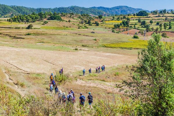 tourists trekking through the scenic landscape of Kalaw